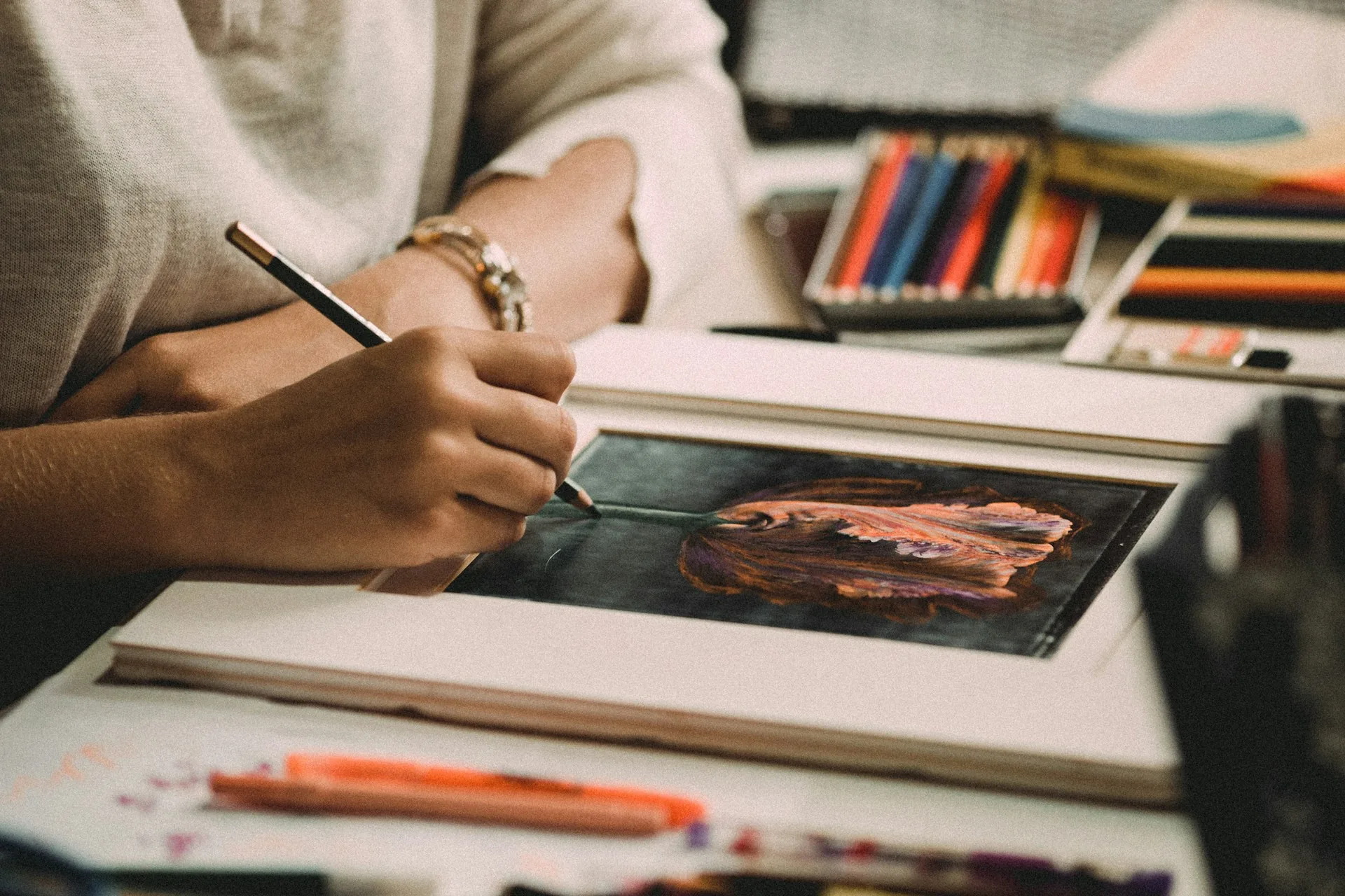 A student working in an art school studio surrounded by work in progress